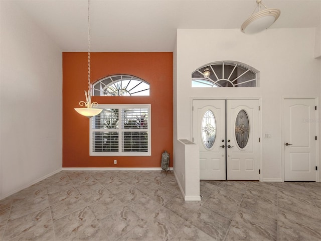 entryway featuring a towering ceiling