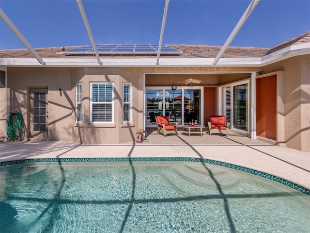 view of swimming pool with a lanai, ceiling fan, and a patio area