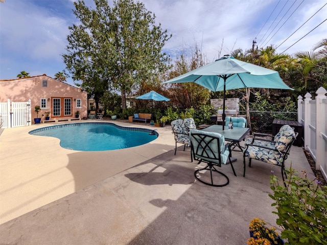 view of swimming pool with a patio area and french doors