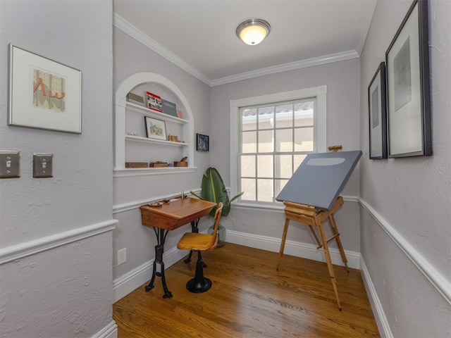 misc room featuring crown molding, wood-type flooring, a healthy amount of sunlight, and built in features