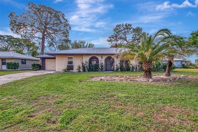 ranch-style house with a garage and a front yard