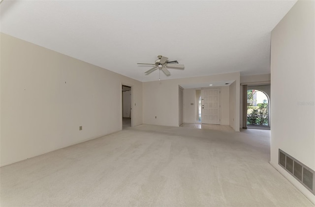 carpeted spare room featuring a textured ceiling and ceiling fan