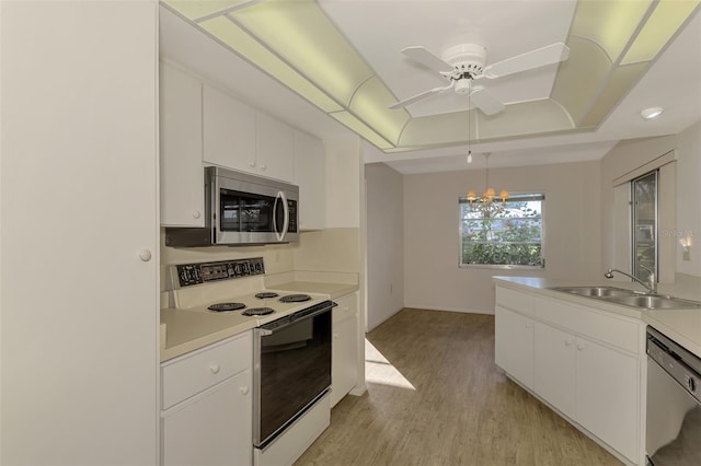 kitchen featuring electric stove, sink, dishwasher, and white cabinets