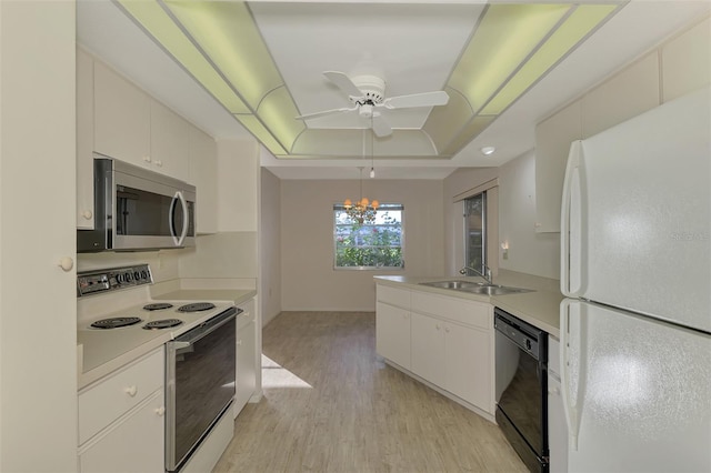 kitchen with sink, white appliances, light hardwood / wood-style flooring, white cabinetry, and a tray ceiling