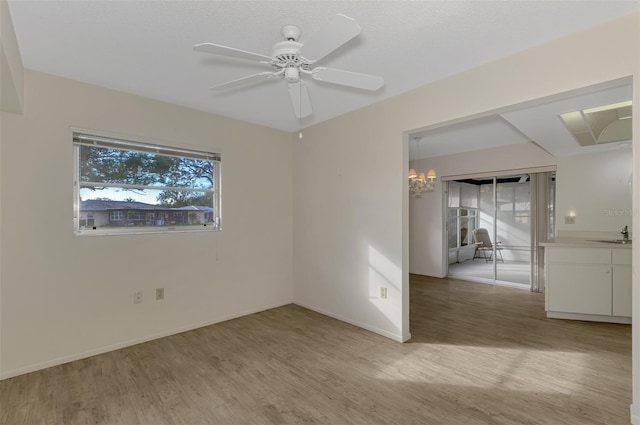 spare room featuring ceiling fan, sink, and light hardwood / wood-style floors