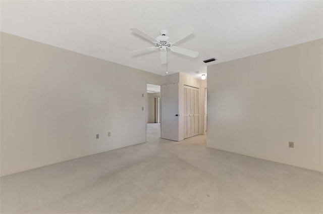 carpeted empty room with ceiling fan