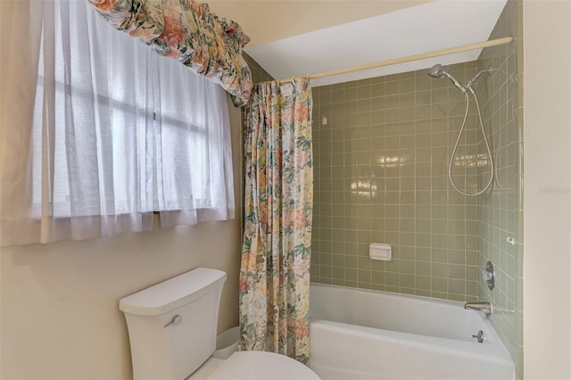 bathroom featuring shower / tub combo with curtain and toilet