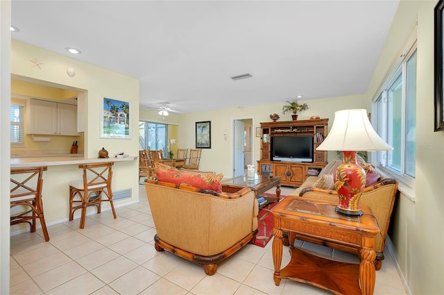 living room with light tile patterned floors and ceiling fan