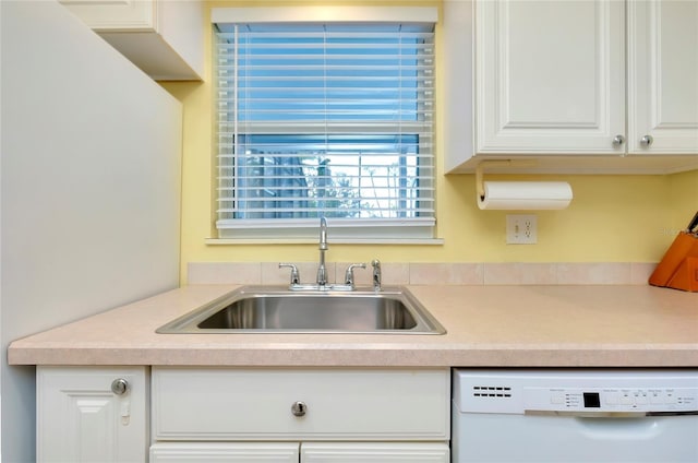 kitchen featuring white cabinetry, white dishwasher, and sink