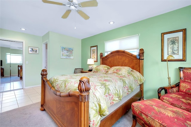 tiled bedroom with ceiling fan and a closet