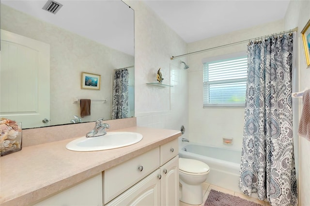 full bathroom with tile patterned floors, vanity, toilet, and shower / bath combo with shower curtain