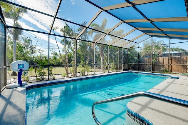 view of swimming pool with a patio and a lanai