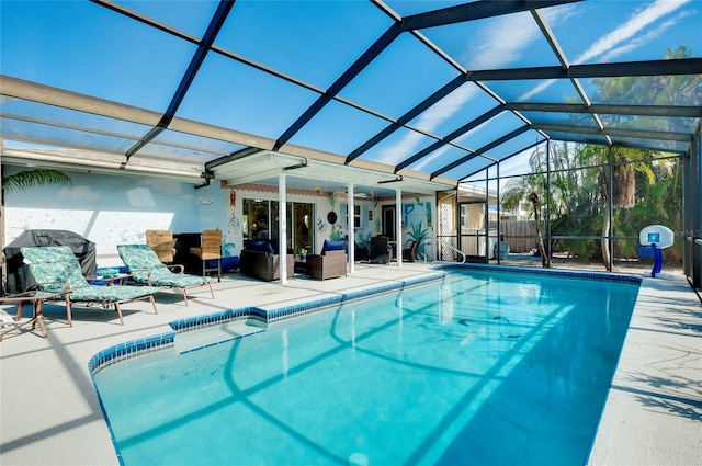 view of swimming pool featuring outdoor lounge area, a patio, and glass enclosure