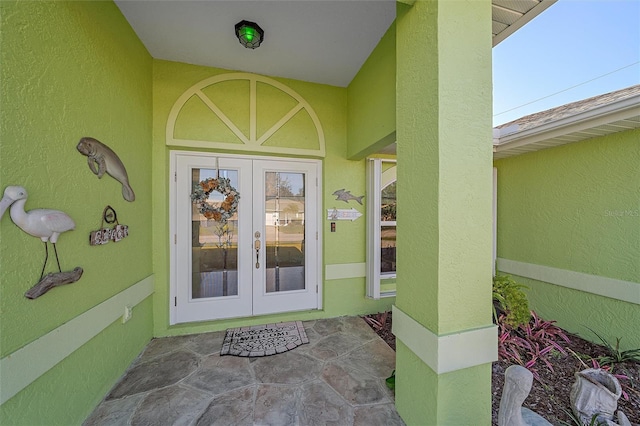 view of exterior entry featuring french doors