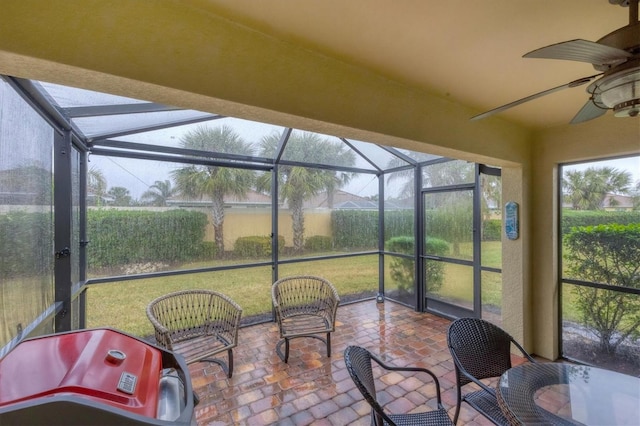 sunroom / solarium featuring ceiling fan