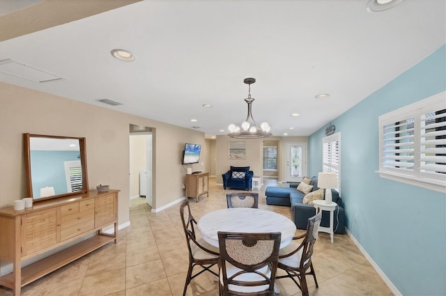 dining room featuring light tile patterned flooring and a notable chandelier