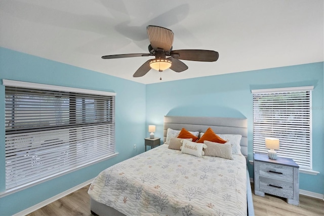 bedroom featuring light wood-type flooring and ceiling fan