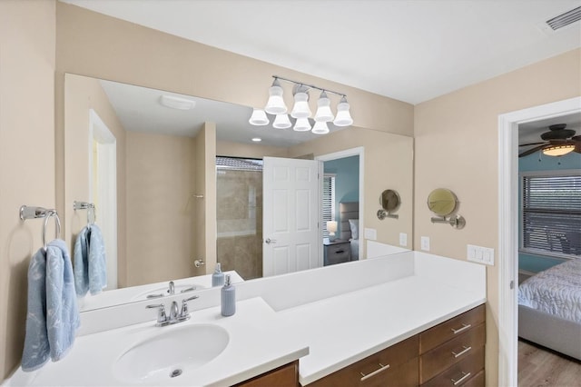 bathroom featuring vanity, a shower, hardwood / wood-style floors, and ceiling fan