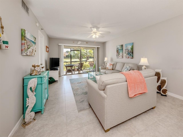 living room featuring light tile patterned floors and ceiling fan