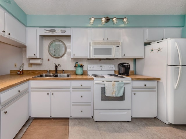 kitchen featuring sink, a textured ceiling, white cabinets, and white appliances