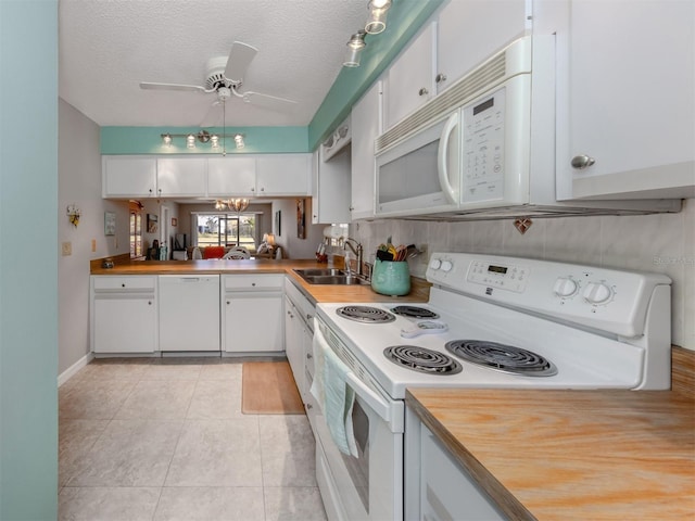 kitchen featuring white cabinetry, sink, ceiling fan, and white appliances