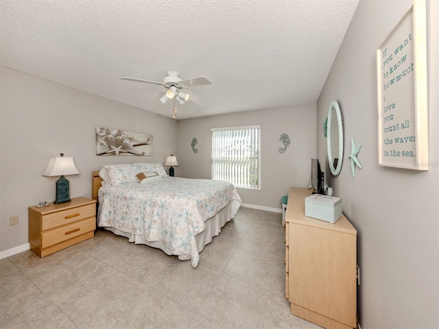 bedroom featuring ceiling fan and a textured ceiling