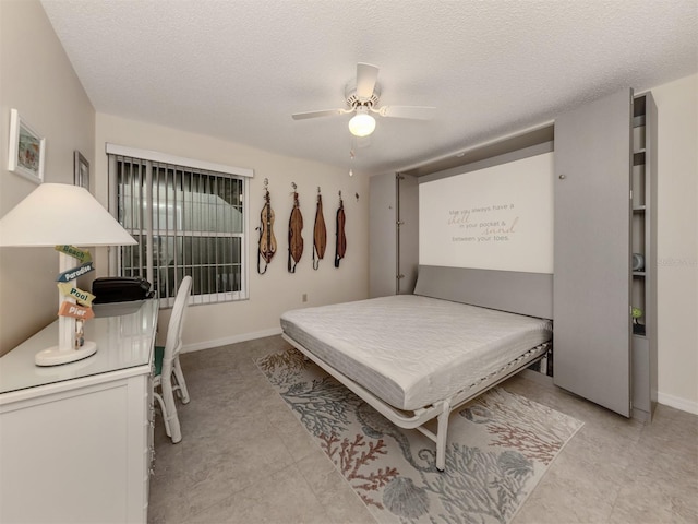 bedroom with ceiling fan and a textured ceiling