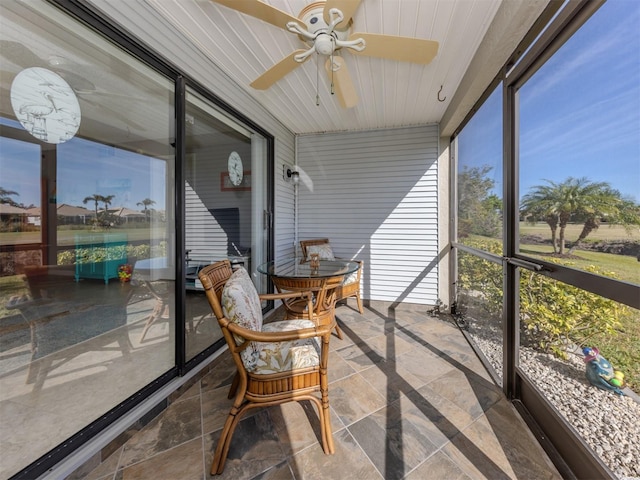 sunroom featuring ceiling fan