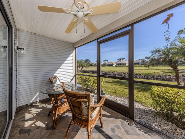 sunroom featuring ceiling fan