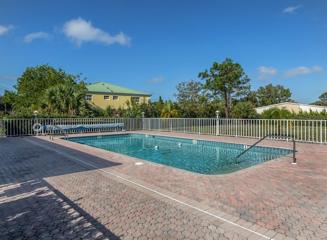 view of swimming pool featuring a patio area