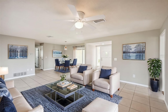 tiled living room featuring ceiling fan