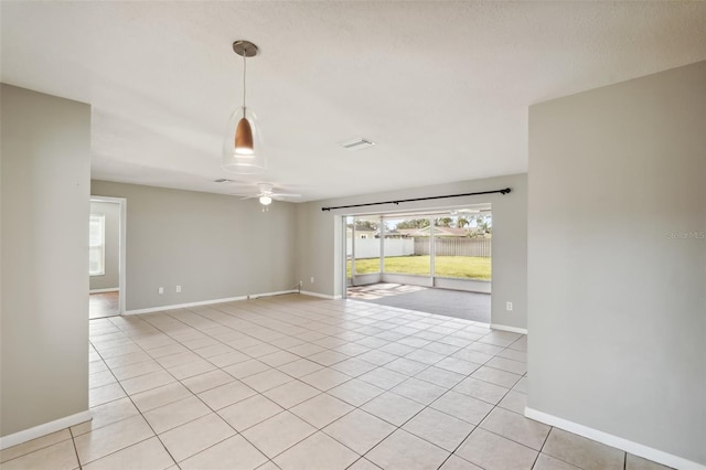 unfurnished room with light tile patterned floors and ceiling fan