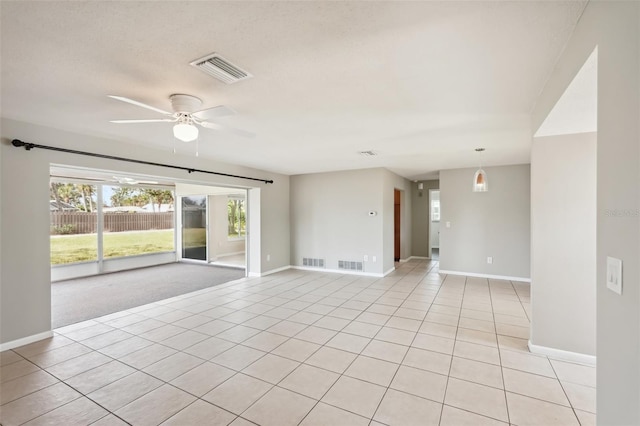 tiled spare room featuring a textured ceiling and ceiling fan