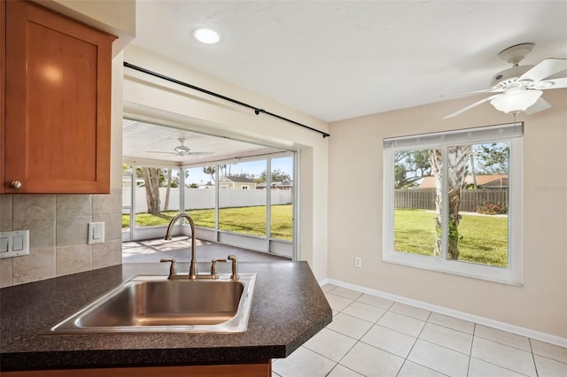 kitchen with ceiling fan, sink, decorative backsplash, and light tile patterned floors