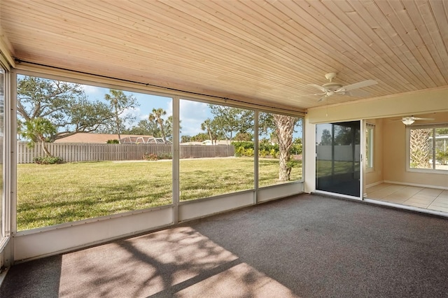 unfurnished sunroom featuring ceiling fan and wooden ceiling