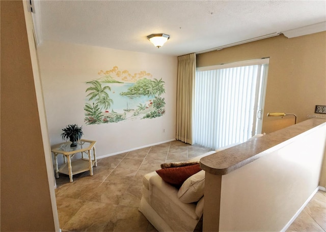 living area with a textured ceiling and light tile patterned floors