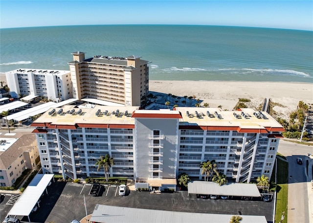 birds eye view of property with a beach view and a water view