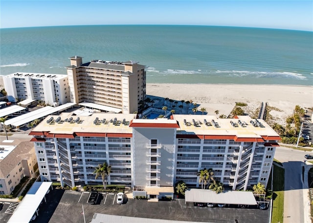 aerial view with a water view and a beach view