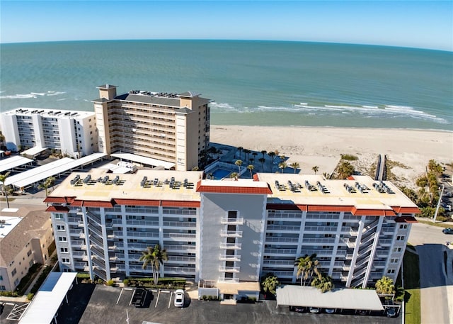 drone / aerial view featuring a water view and a view of the beach