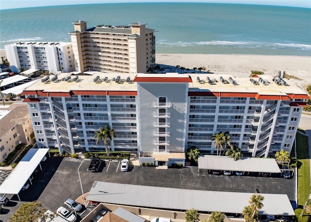 drone / aerial view featuring a water view and a beach view