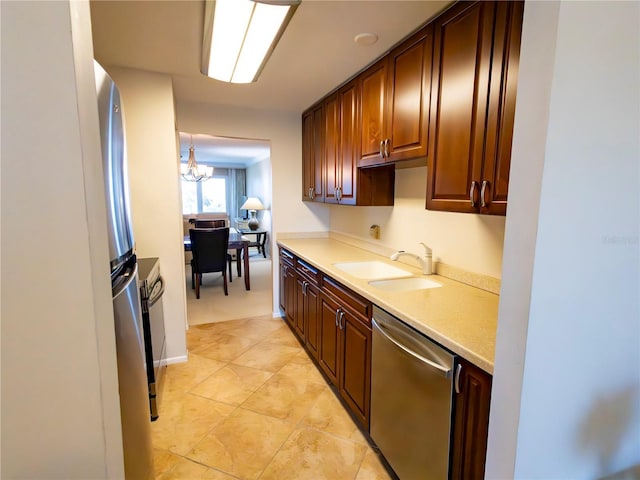 kitchen with sink, crown molding, decorative light fixtures, light tile patterned floors, and stainless steel appliances