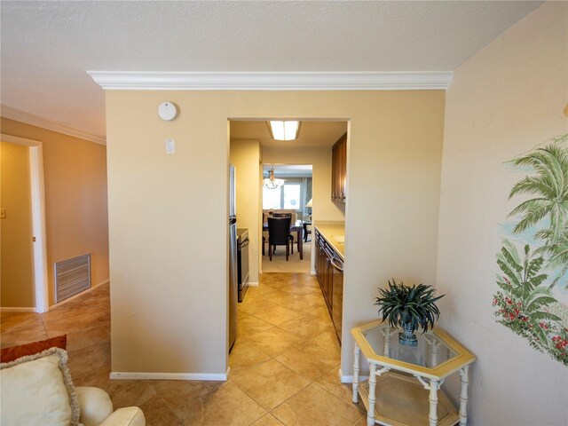 hall featuring crown molding and light tile patterned floors