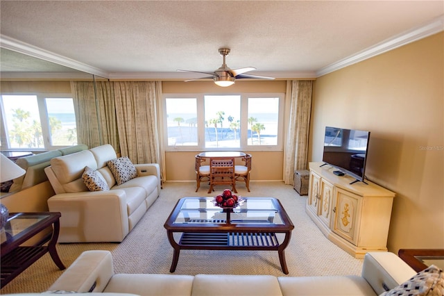 living room with light carpet, ceiling fan, ornamental molding, and a textured ceiling