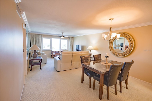 carpeted dining room with crown molding and ceiling fan with notable chandelier