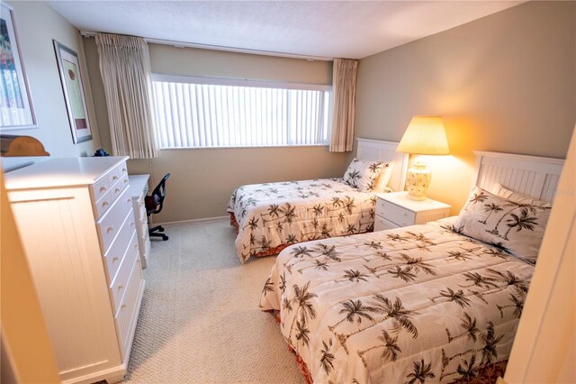 bedroom featuring light colored carpet