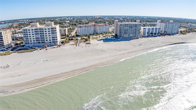 bird's eye view featuring a water view and a beach view