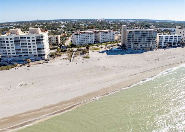 birds eye view of property featuring a water view and a view of the beach