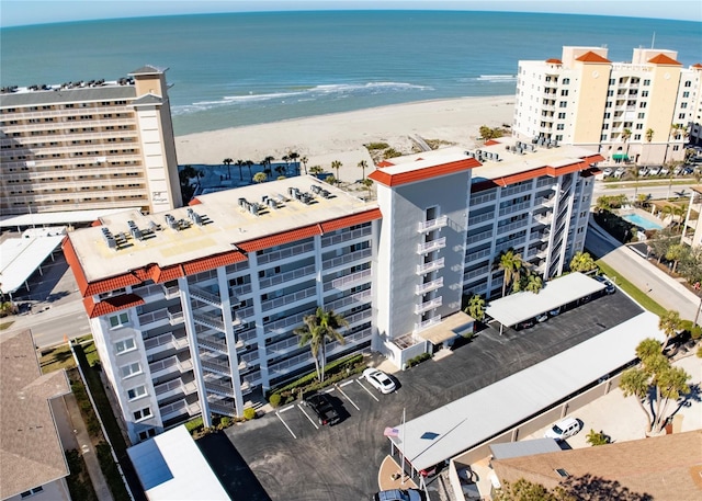 birds eye view of property featuring a water view and a view of the beach