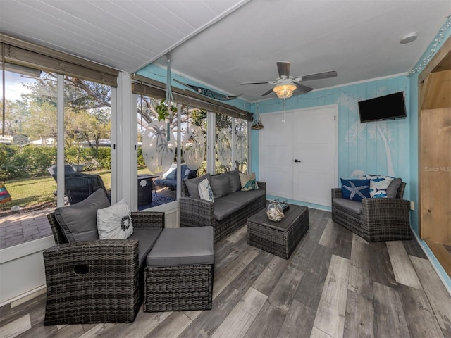 sunroom / solarium featuring ceiling fan