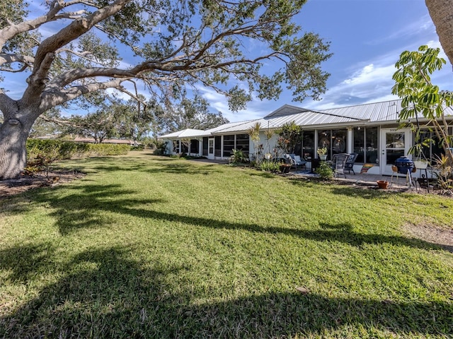 view of yard with a patio area and a sunroom